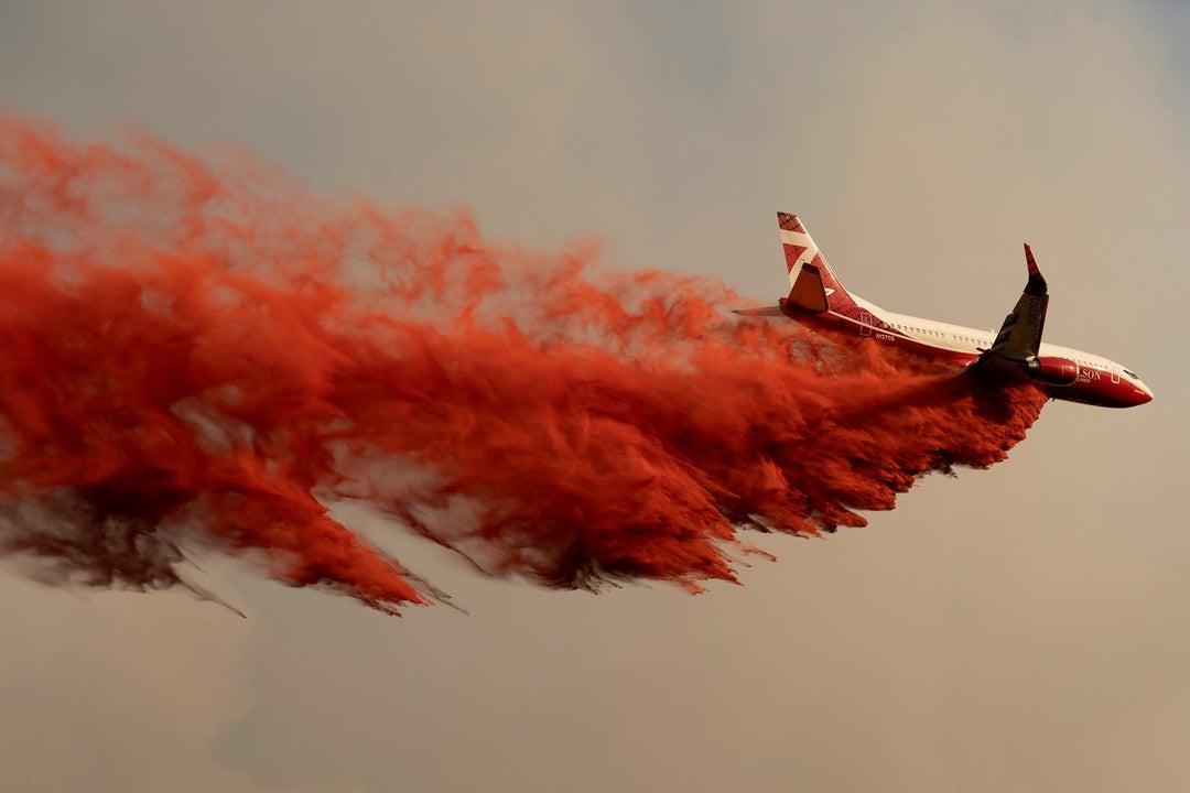 [1800x1200] An airplane drops fire retardant on the Chuweah Creek Fire as wildfires devastate Nespelem in eastern Washington state. 15 July 2021 (Reuters/David Ryder)