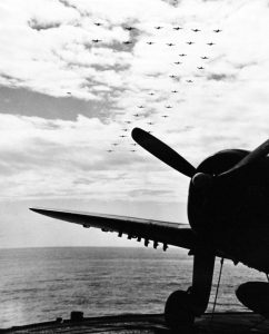 USS Enterprise (CV-6), 1945 Group of Navy planes flying in formation over USS Enterprise (CV 6) prior to her entrance into Pearl Harbor, [1034x1280]