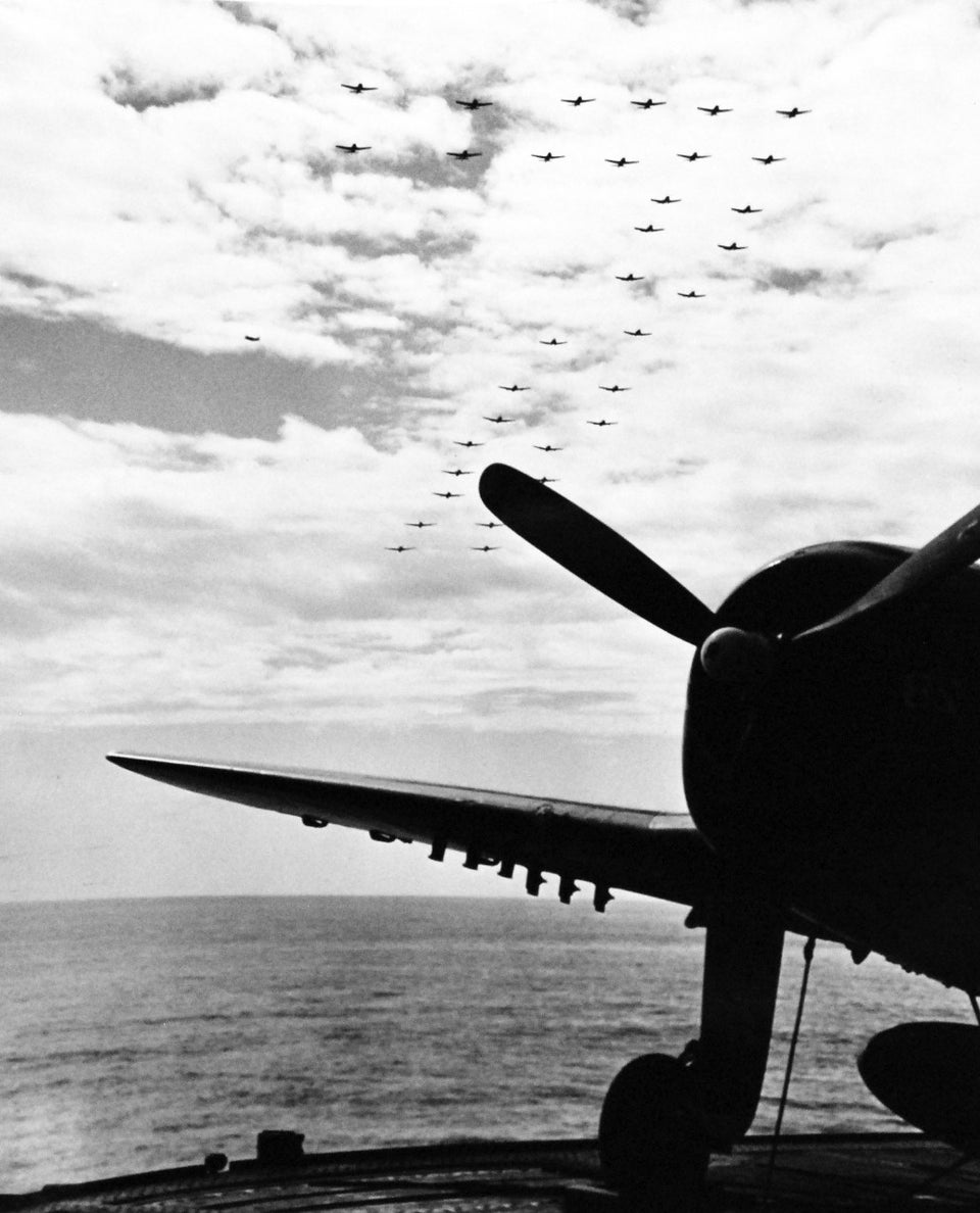 USS Enterprise (CV-6), 1945 Group of Navy planes flying in formation over USS Enterprise (CV 6) prior to her entrance into Pearl Harbor, [1034x1280]