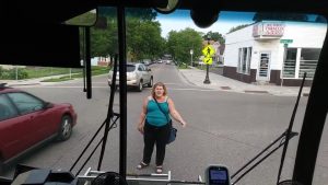 Lady won't let bus drive away after getting kicked off, breaks the bus window, cries, then runs off.