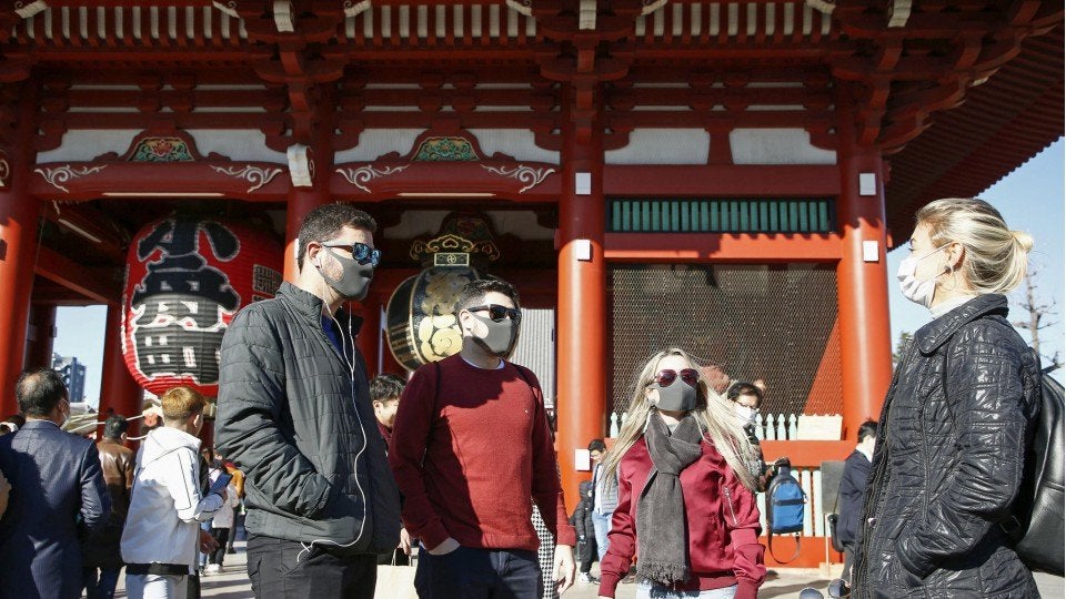 Japan to ask foreign tourists to wear masks, take out insurance