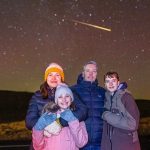 A family photo with the Northern Lights became a "one-in-a-million" shot after a shooting star flew in the background.