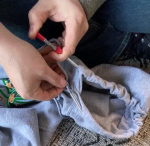 Using a mechanic’s tool to re-thread a hoodie