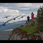 C-130 aircraft flying in close formation