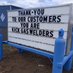 This sign for a compressed gas distributor uses compressed gas canisters