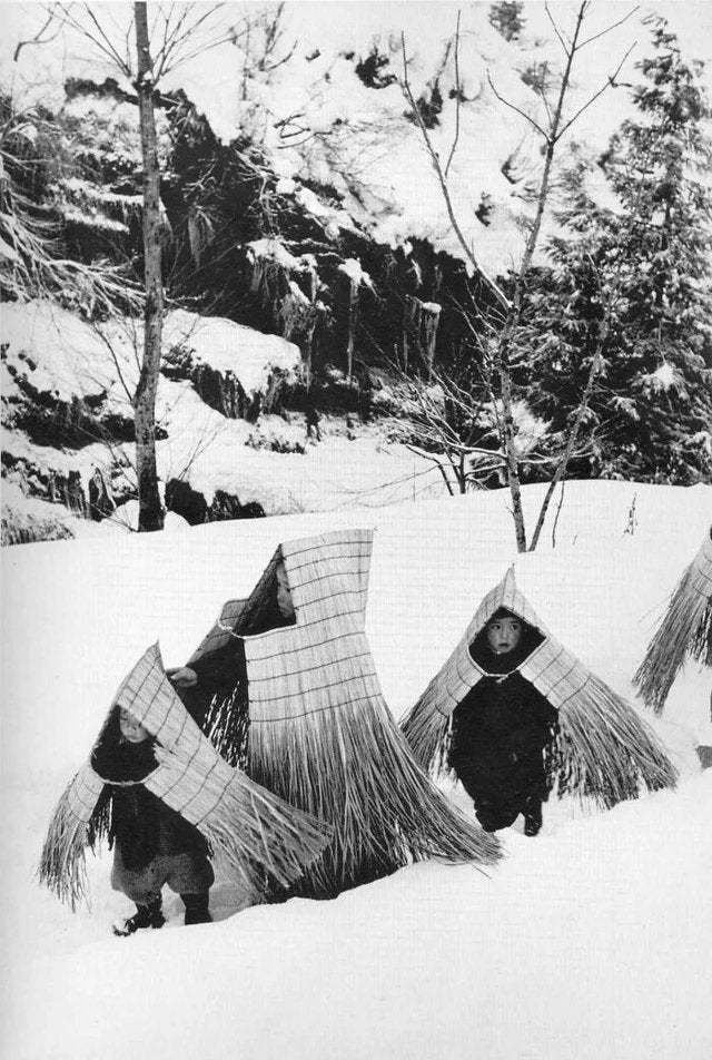 Children in minobashi raincoats going to a new year's event,Niigata prefecture, Japan 1956