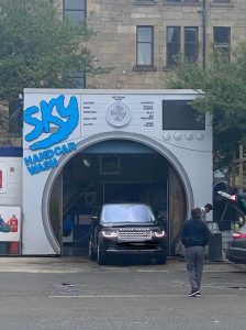 Car wash designed to look like a washing machine