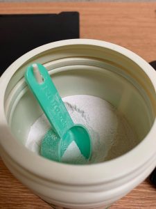 My preworkout container has a little hook to hang the scoop on