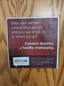 All the tabs are taken off this domestic violence flyer in a women's restroom