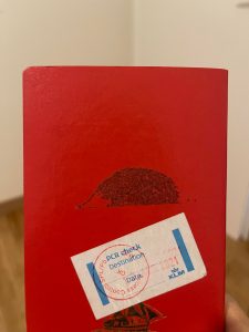 A bit of glue from an old sticker on the back of my passport looks like a hedgehog