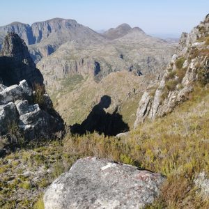 This shadow in the mountains looks like a girl reading.